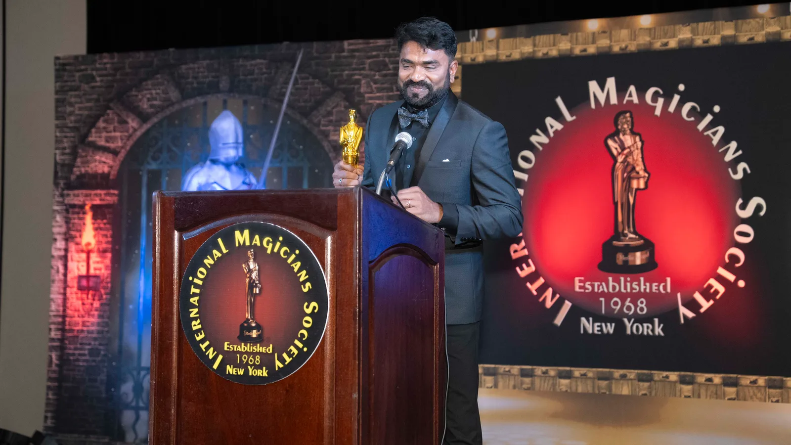 Aravind V.K. speaking at the International Magicians Society podium